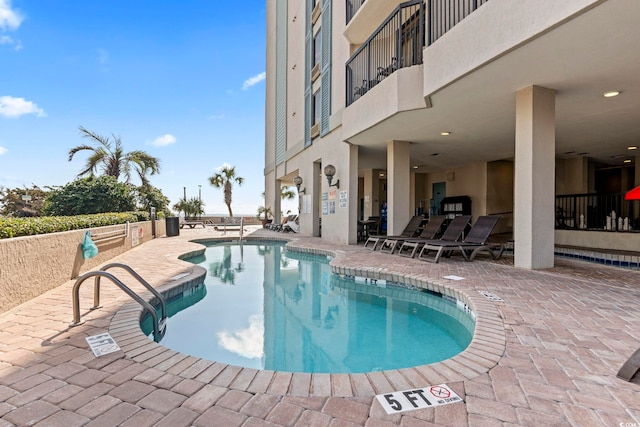 view of swimming pool featuring a patio area