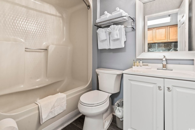 full bathroom with vanity, bathtub / shower combination, hardwood / wood-style floors, and toilet