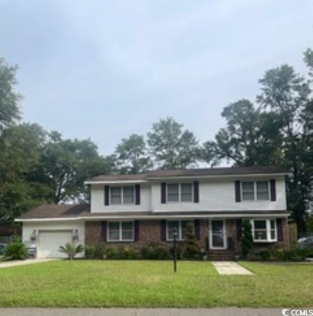 front of property with a garage and a front lawn