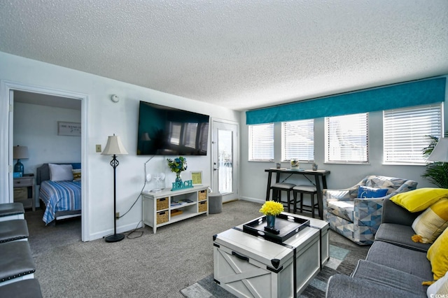 carpeted living room featuring a textured ceiling