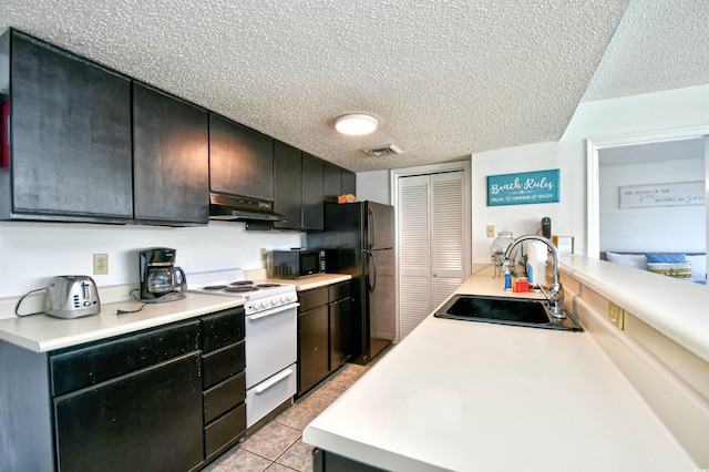 kitchen featuring sink, light tile patterned floors, a textured ceiling, and black appliances