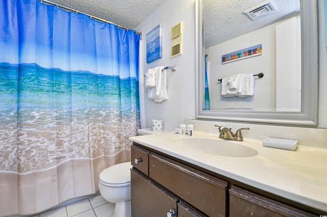 bathroom with vanity, tile patterned flooring, toilet, and a textured ceiling