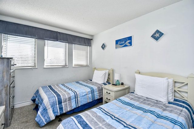 carpeted bedroom featuring a textured ceiling