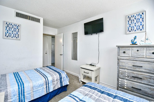 bedroom featuring a textured ceiling and dark carpet