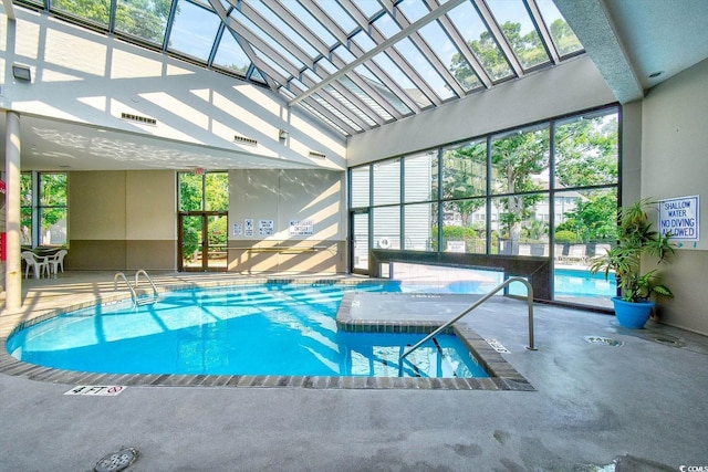 view of swimming pool with a hot tub