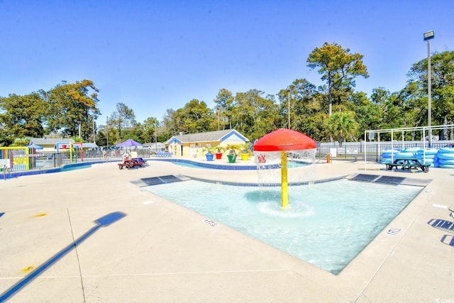 view of pool with pool water feature and a patio area