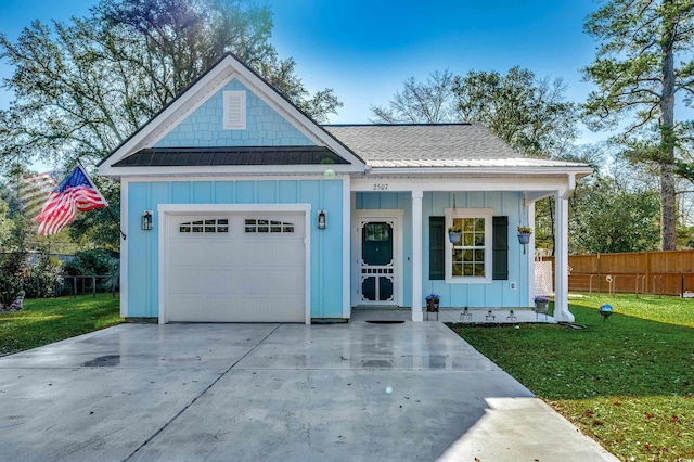 view of front of property with a garage and a front lawn