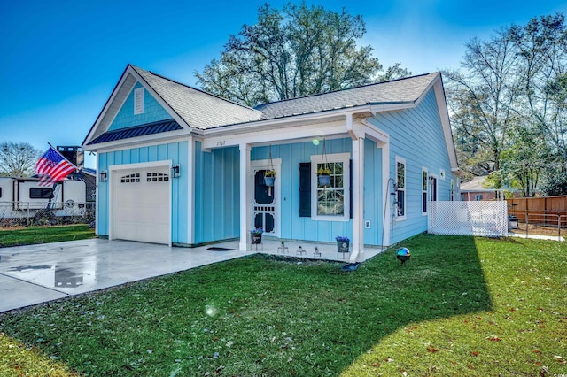 view of front of house with a garage and a front lawn