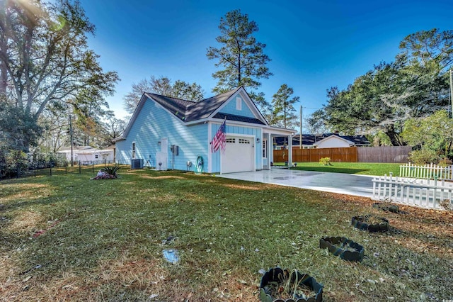 exterior space with cooling unit, a garage, a patio area, and a front yard