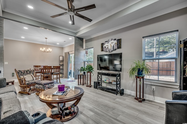 living room with ornamental molding, ceiling fan with notable chandelier, and light hardwood / wood-style flooring