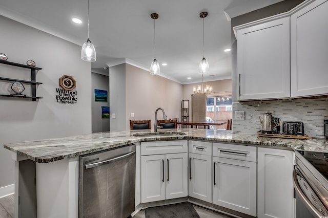 kitchen with hanging light fixtures, appliances with stainless steel finishes, sink, and white cabinets