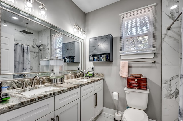 bathroom with walk in shower, vanity, toilet, and a wealth of natural light