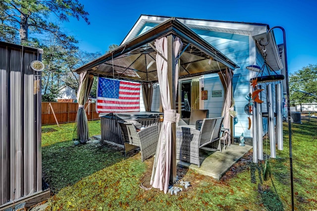 exterior space with a gazebo and a lawn