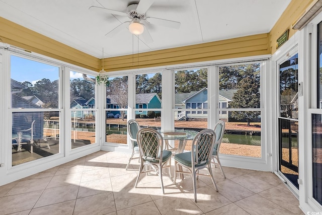 sunroom / solarium featuring ceiling fan