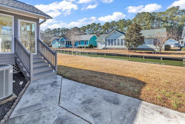 view of yard with cooling unit and a patio