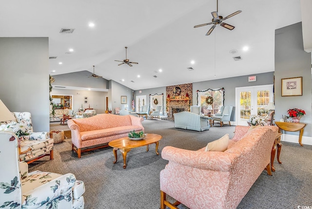 carpeted living room featuring french doors, ceiling fan, high vaulted ceiling, and a brick fireplace