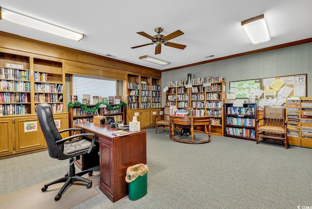 home office with carpet floors, ornamental molding, and ceiling fan