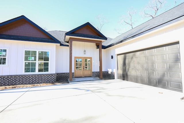 view of front of house featuring a garage and french doors