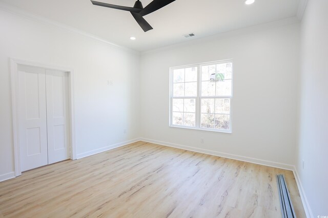 unfurnished bedroom featuring ornamental molding, ceiling fan, and light wood-type flooring