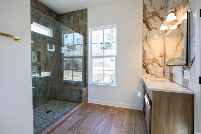 bathroom featuring vanity, plenty of natural light, and a tile shower