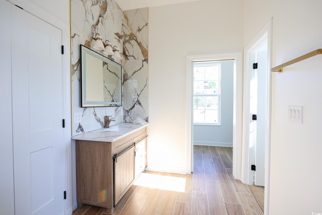 interior space with vanity and hardwood / wood-style floors