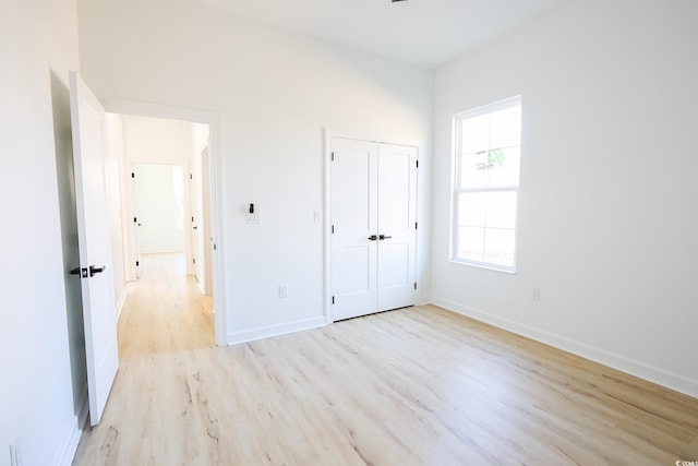 unfurnished bedroom featuring a closet and light hardwood / wood-style flooring