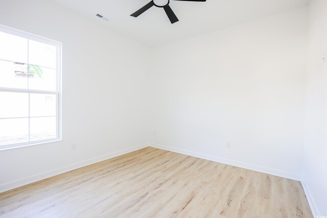 spare room featuring light hardwood / wood-style flooring and ceiling fan