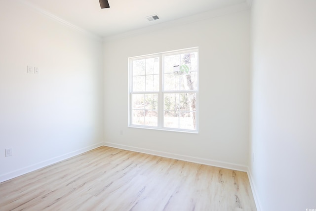 spare room with ornamental molding, ceiling fan, and light wood-type flooring