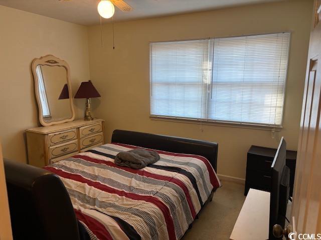 bedroom featuring light carpet