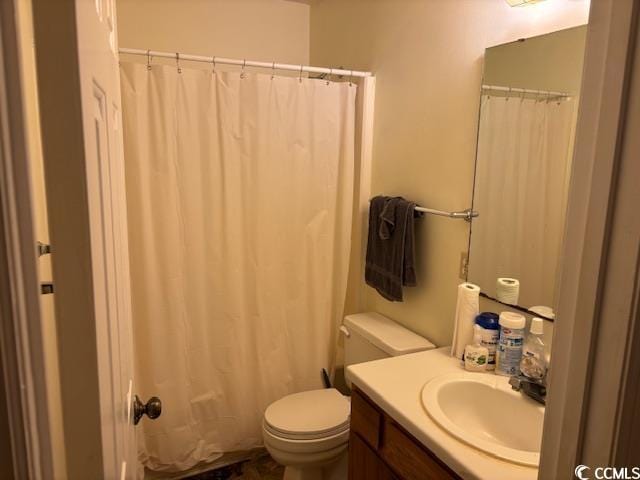 bathroom featuring toilet, curtained shower, and vanity