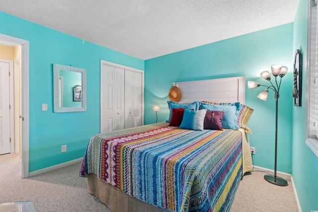 carpeted bedroom with a closet and a textured ceiling