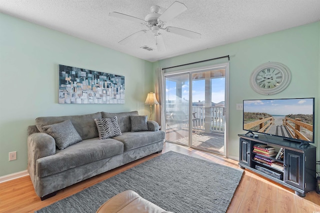 1900 Duffy St Unit C-7, North Myrtle Beach, SC 29582 - living room with ceiling fan, a textured ceiling, visible vents, wood finished floors, and baseboards