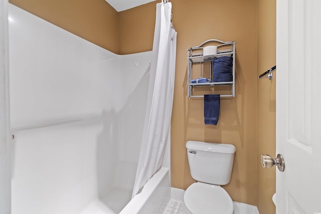 bathroom featuring shower / bath combination with curtain and toilet