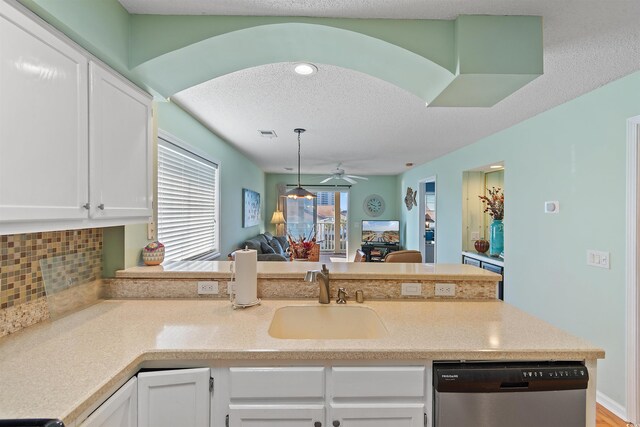 1900 Duffy St Unit C-7, North Myrtle Beach, SC 29582 - kitchen featuring stainless steel dishwasher, a sink, a peninsula, open floor plan, and white cabinetry