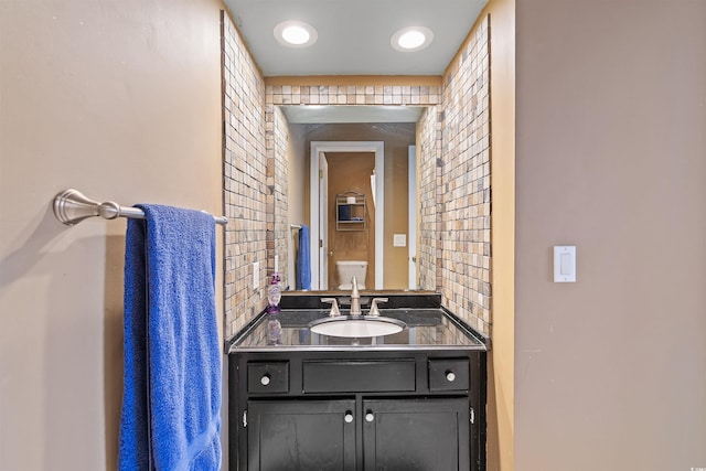 1900 Duffy St Unit C-7, North Myrtle Beach, SC 29582 - bathroom featuring vanity, brick wall, and toilet