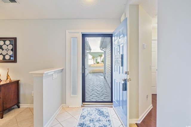 tiled entrance foyer with a textured ceiling