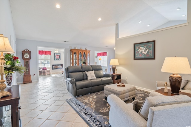 living room with lofted ceiling and light tile patterned floors