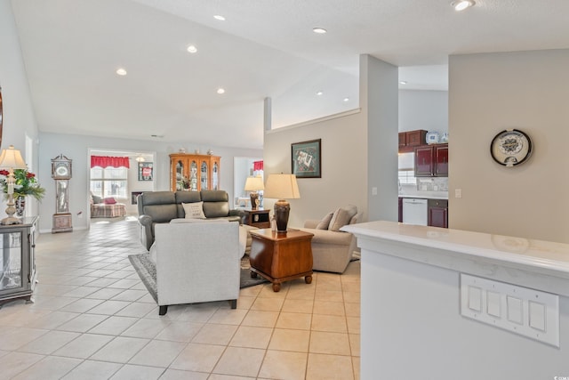 living room featuring vaulted ceiling and light tile patterned floors