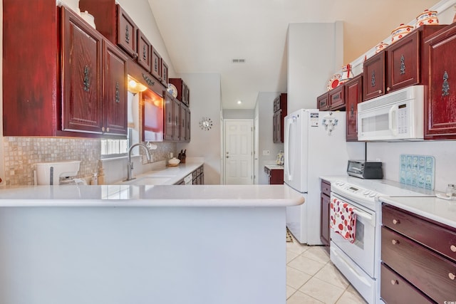 kitchen featuring white appliances, kitchen peninsula, sink, and light tile patterned floors