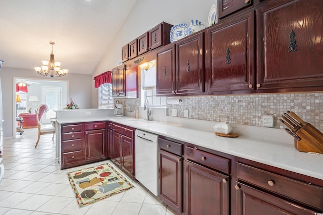 kitchen featuring vaulted ceiling, hanging light fixtures, plenty of natural light, kitchen peninsula, and dishwasher