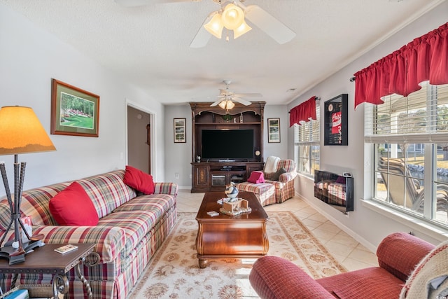 tiled living room featuring heating unit, a fireplace, a wealth of natural light, and ceiling fan