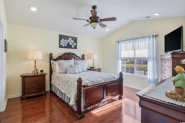 bedroom featuring dark wood-type flooring, ceiling fan, vaulted ceiling, and a textured ceiling