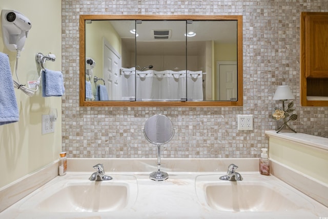 bathroom featuring vanity and decorative backsplash