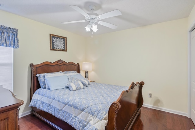 bedroom with dark wood-type flooring and ceiling fan