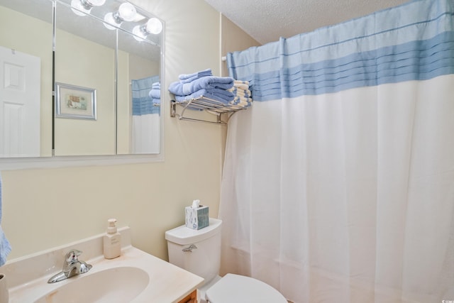 full bathroom featuring vanity, shower / tub combo, toilet, and a textured ceiling