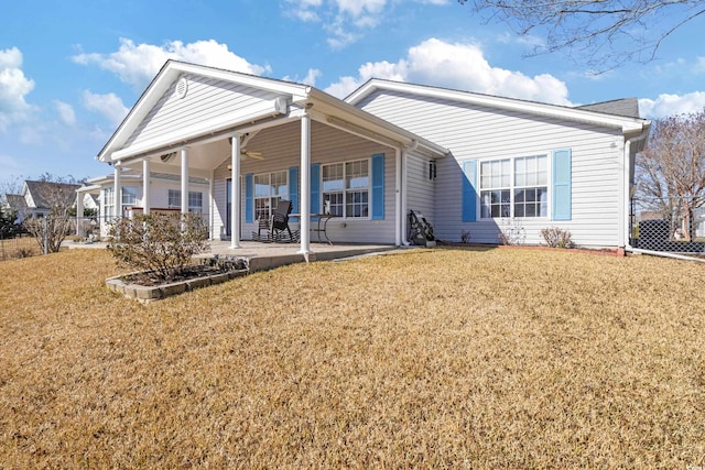 rear view of house with a patio area, ceiling fan, and a lawn