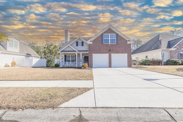 front of property with a porch and a garage