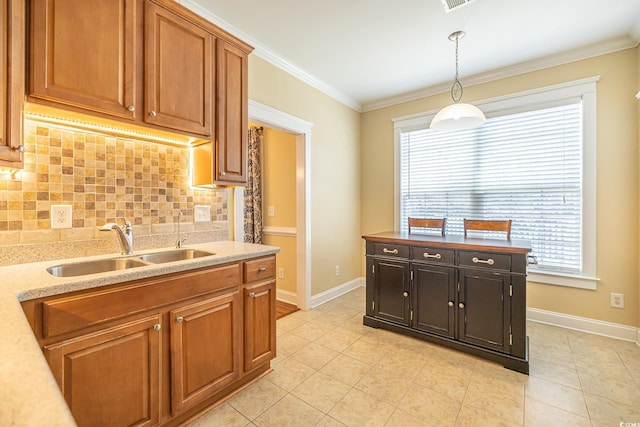 kitchen with light tile patterned flooring, sink, decorative light fixtures, ornamental molding, and decorative backsplash