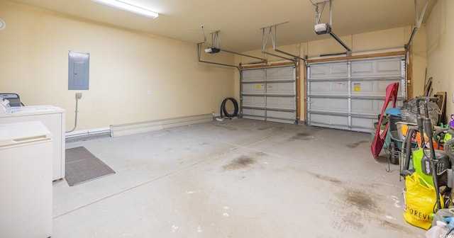 garage featuring separate washer and dryer, a garage door opener, and electric panel