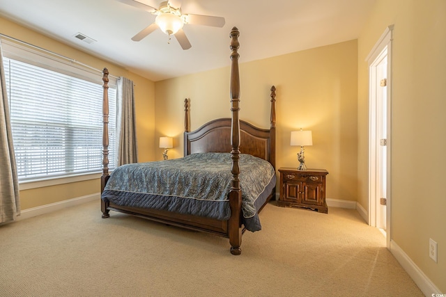 bedroom with ceiling fan and light colored carpet